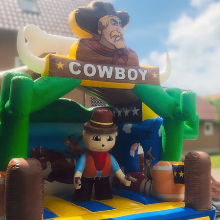 Cowboy Hüpfburg mit einer seitlichen Rutsche